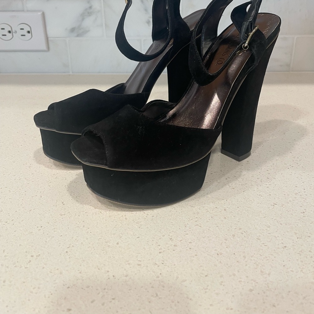 Black suede-like platform heels with ankle strap